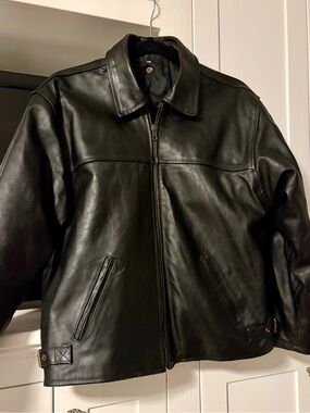 Vintage men’s black leather biker jacket with “Fiocchi Italy” snap fasteners